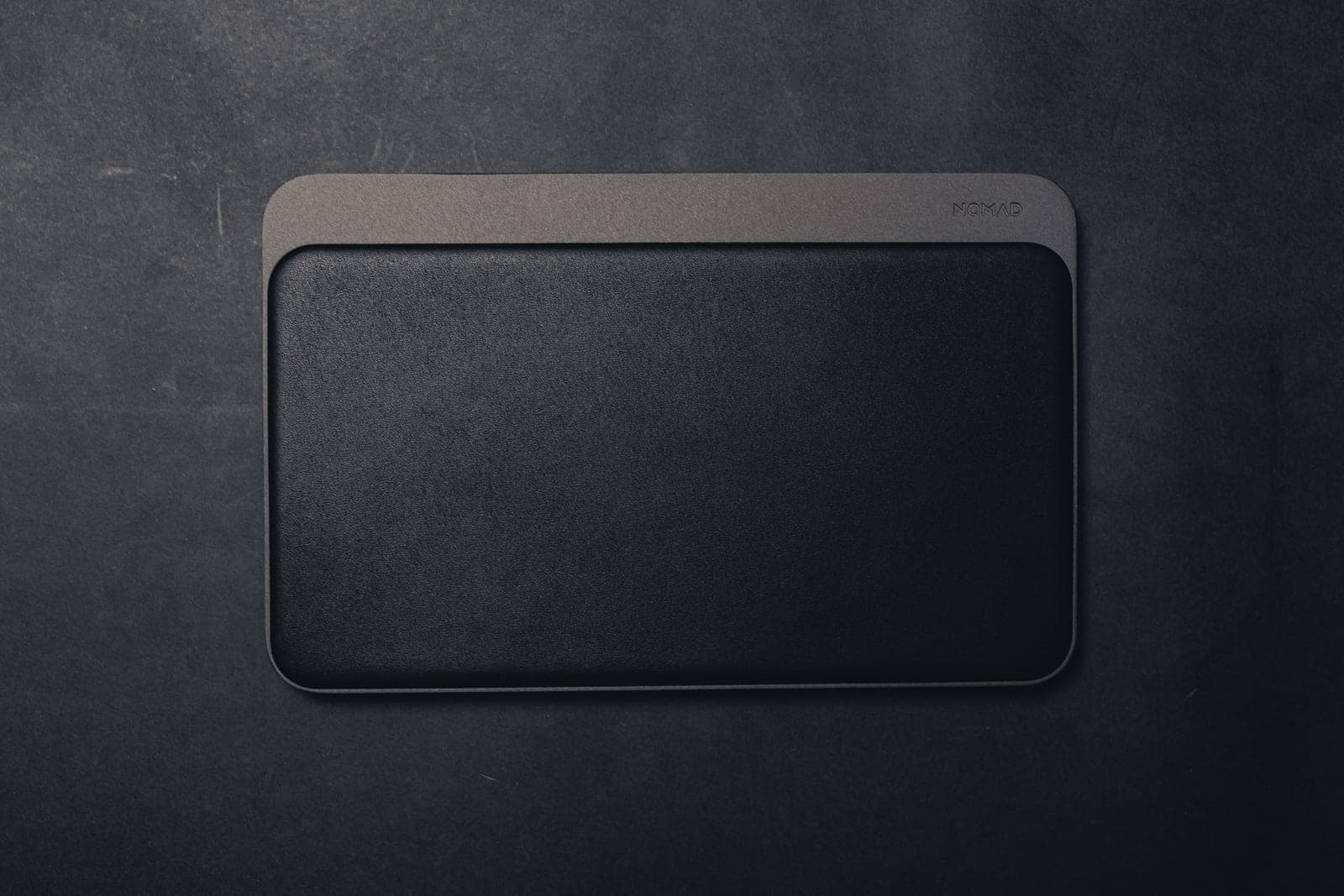 A close view of a brown leather desk pad surface texture