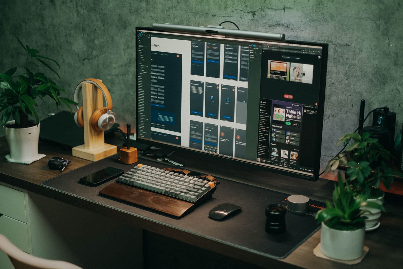 A computer monitor raised on a wooden stand on a desk