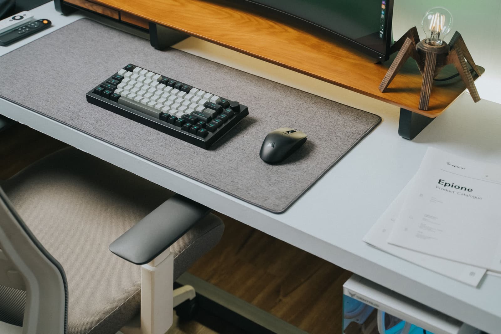 A leather desk mat under a keyboard and mouse in a warm office