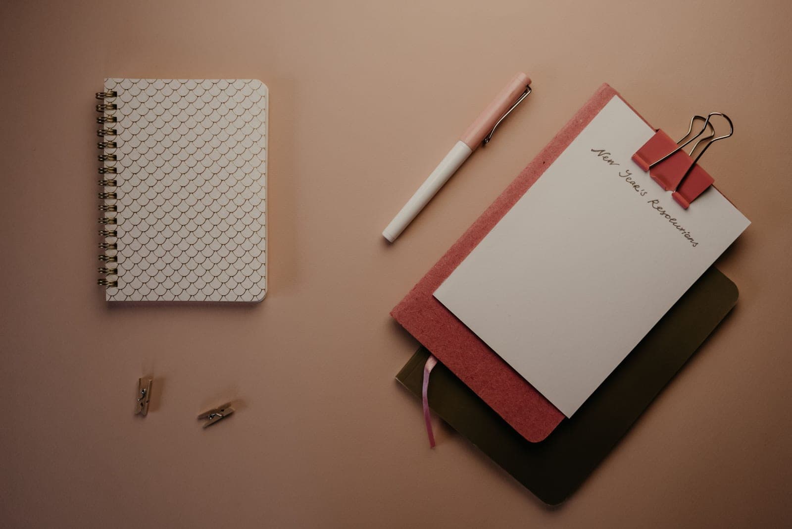 A new desk set up with a notebook and pen ready for a first day