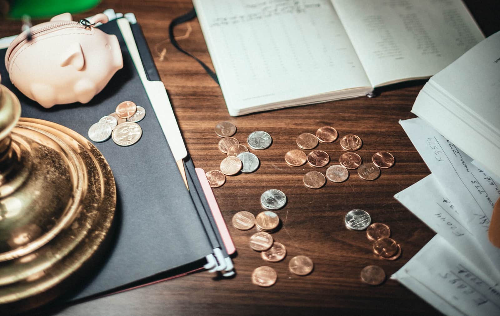 Coins and a small wrapped gift on a desk