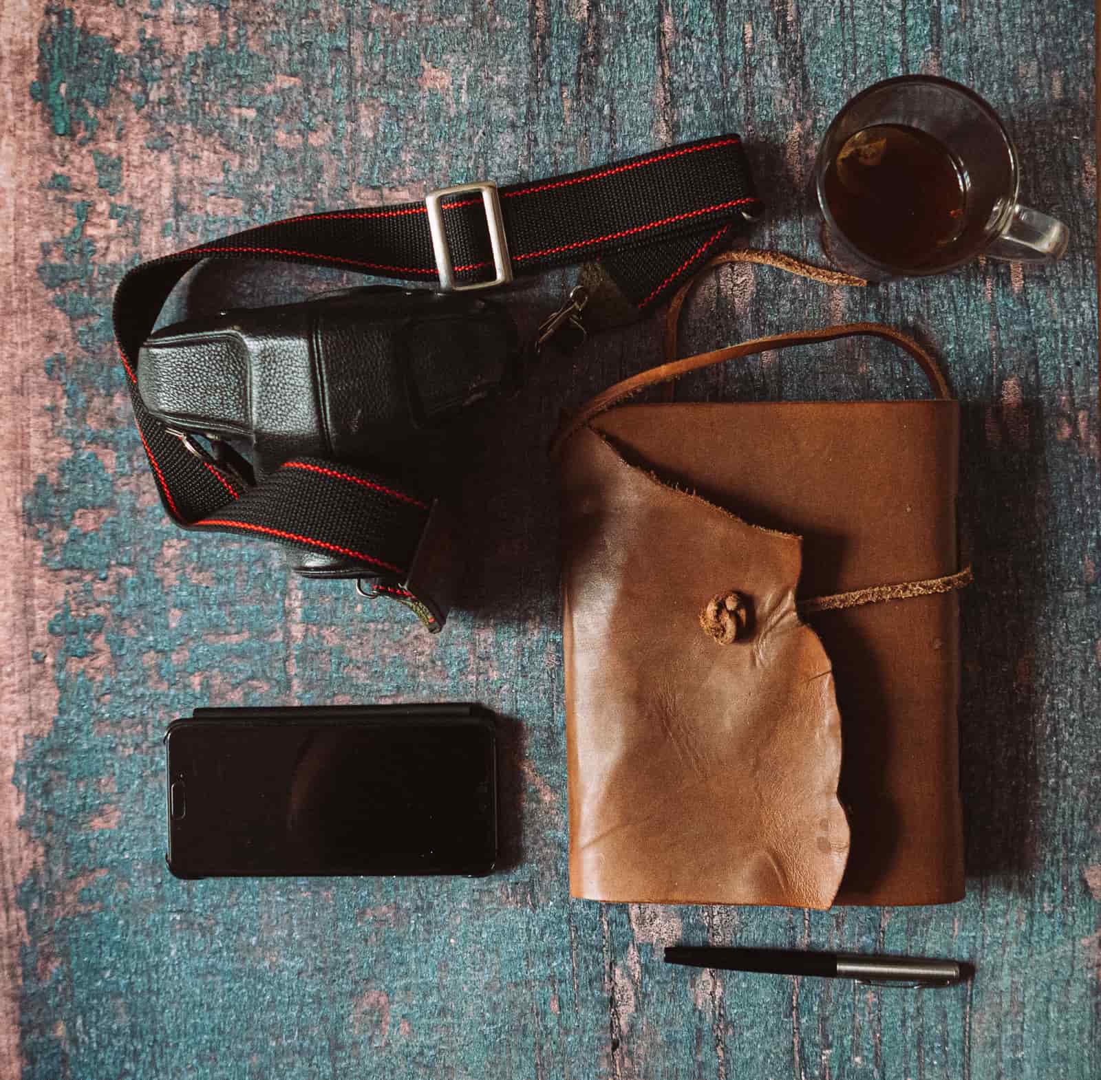 A leather journal and pen gift set on a table
