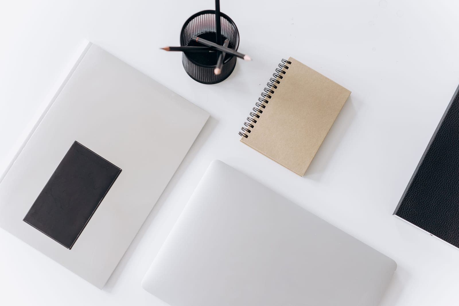 Notebooks of several sizes fanned out on a desk
