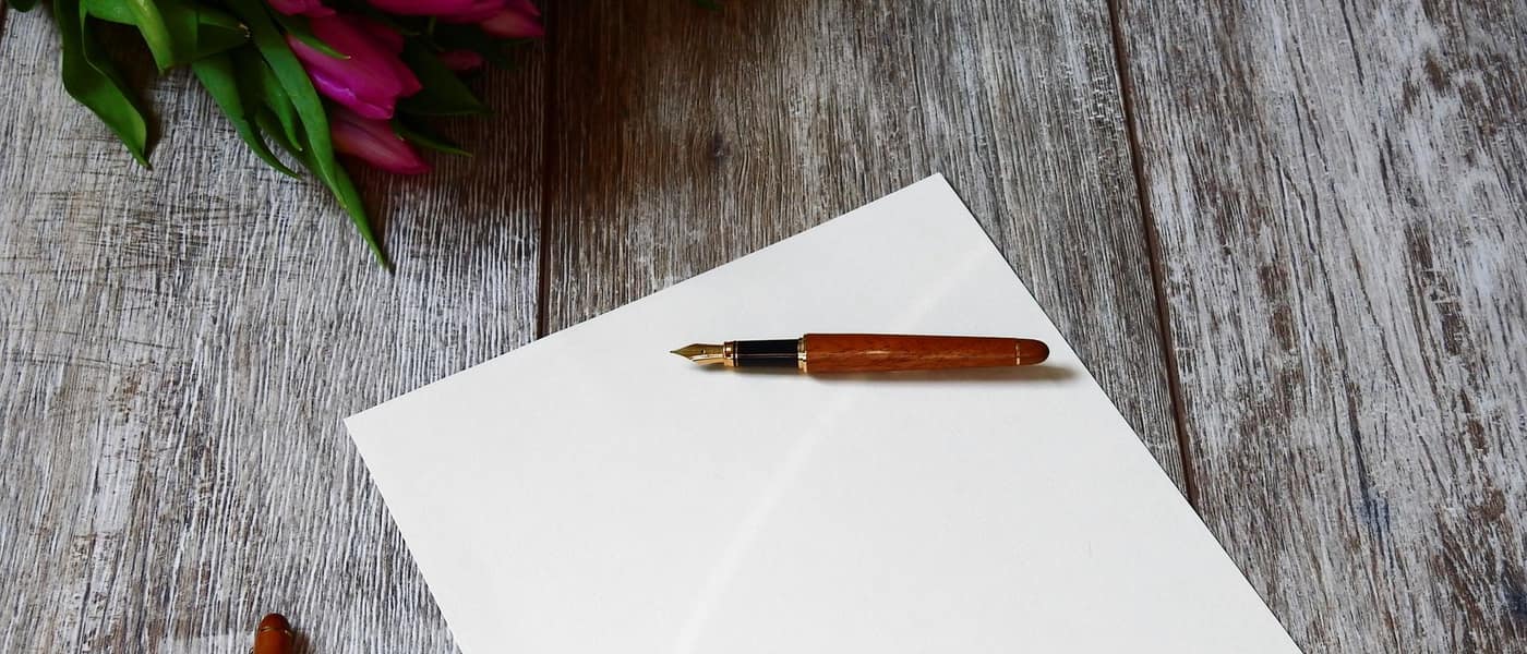 A fountain pen lying on a sheet of blank white paper