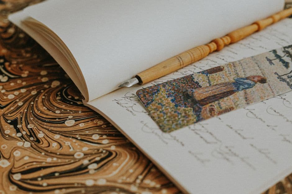 An open notebook with a fountain pen resting on the page